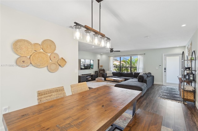 dining room with ceiling fan and dark hardwood / wood-style floors