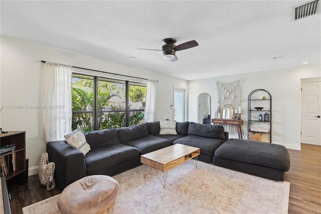 living room featuring hardwood / wood-style flooring and ceiling fan