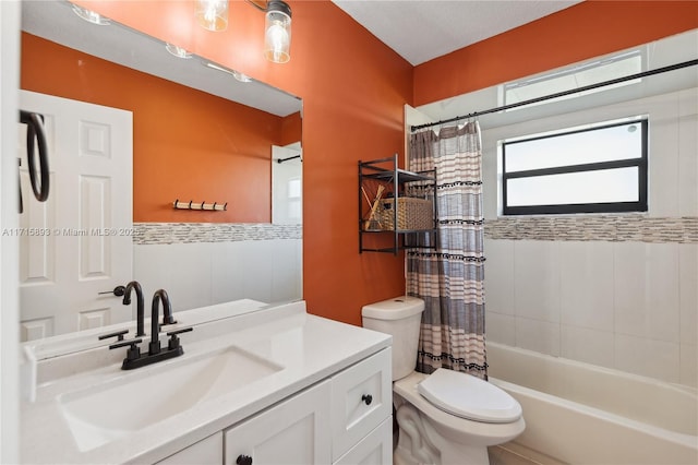 full bathroom featuring vanity, shower / tub combo, and toilet