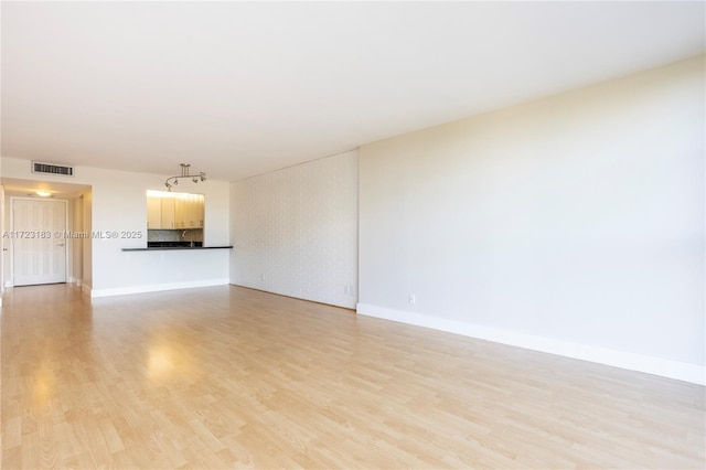 unfurnished living room featuring light hardwood / wood-style floors