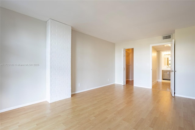 spare room featuring light wood-type flooring