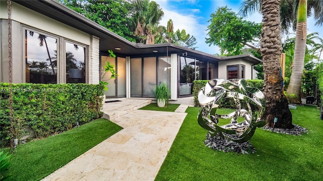 doorway to property with a yard