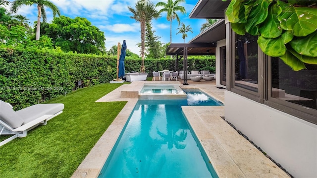 view of swimming pool featuring an in ground hot tub, a patio area, and a lawn