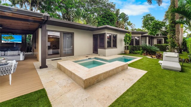 back of house featuring an in ground hot tub and a lawn