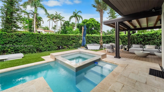 view of swimming pool featuring an in ground hot tub and a patio