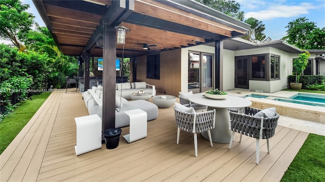 wooden deck featuring a pool with hot tub and an outdoor hangout area