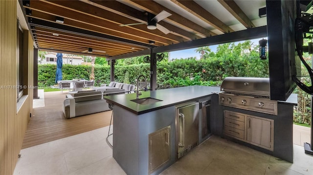 view of patio with area for grilling, sink, a grill, ceiling fan, and an outdoor hangout area