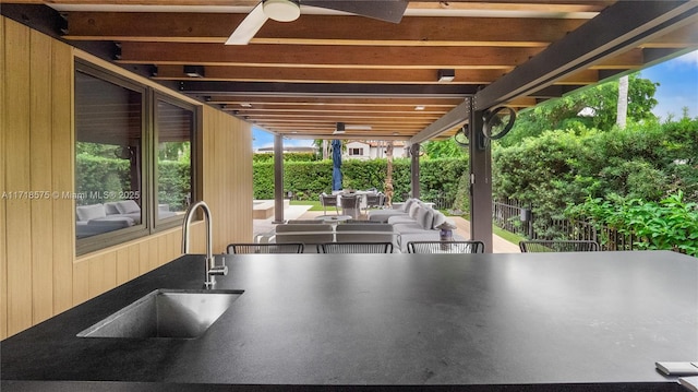 view of patio with ceiling fan and an outdoor wet bar