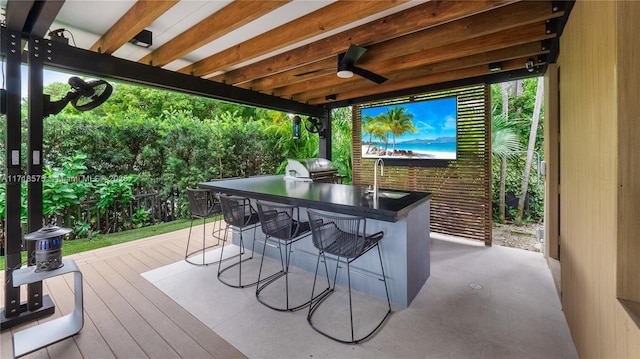 deck with ceiling fan, a grill, and a wet bar