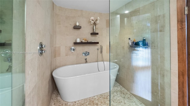 bathroom with independent shower and bath and tile walls