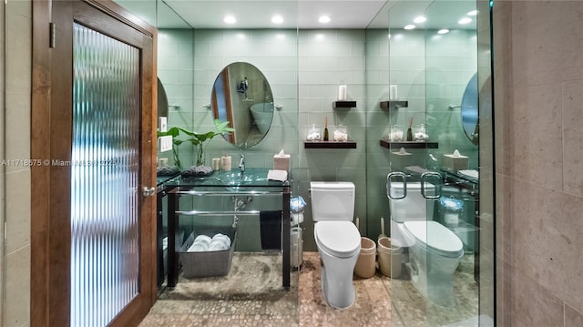 bathroom with sink, tile walls, and toilet