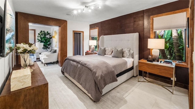 bedroom featuring wooden walls