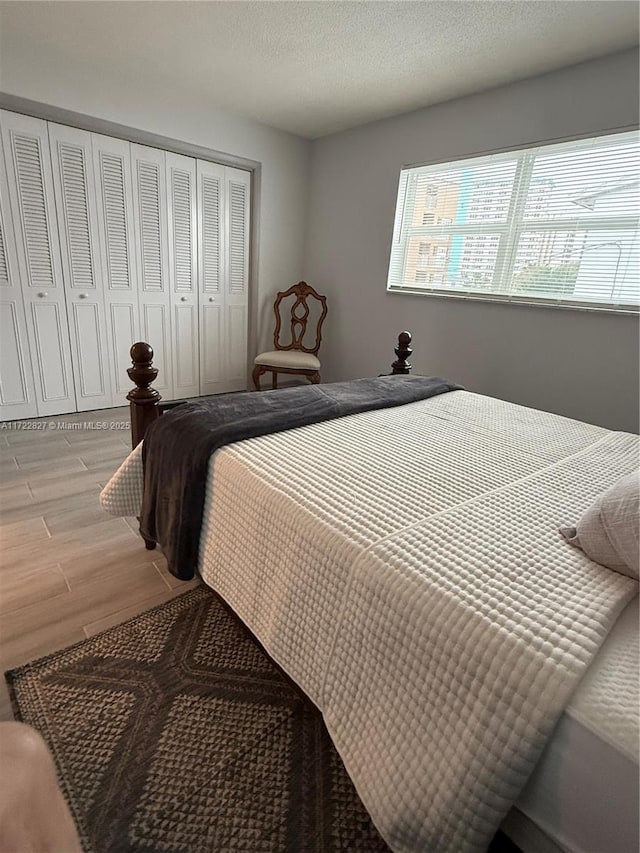 bedroom with a closet and light hardwood / wood-style flooring