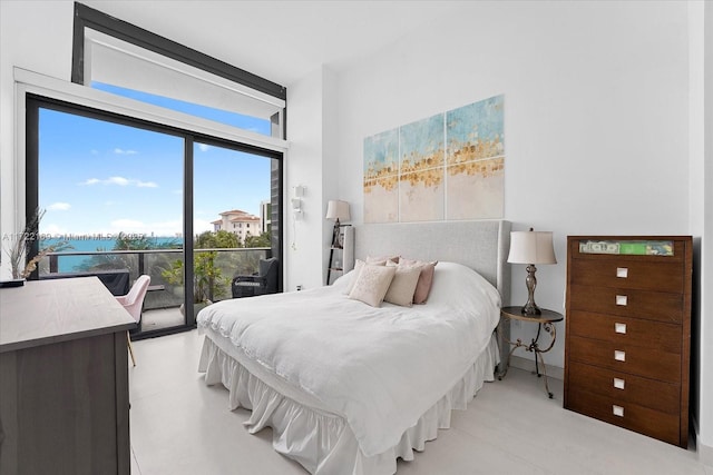 bedroom with access to outside and a water view