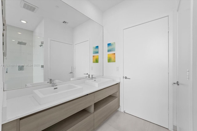 bathroom with tile patterned floors, vanity, and a shower with door