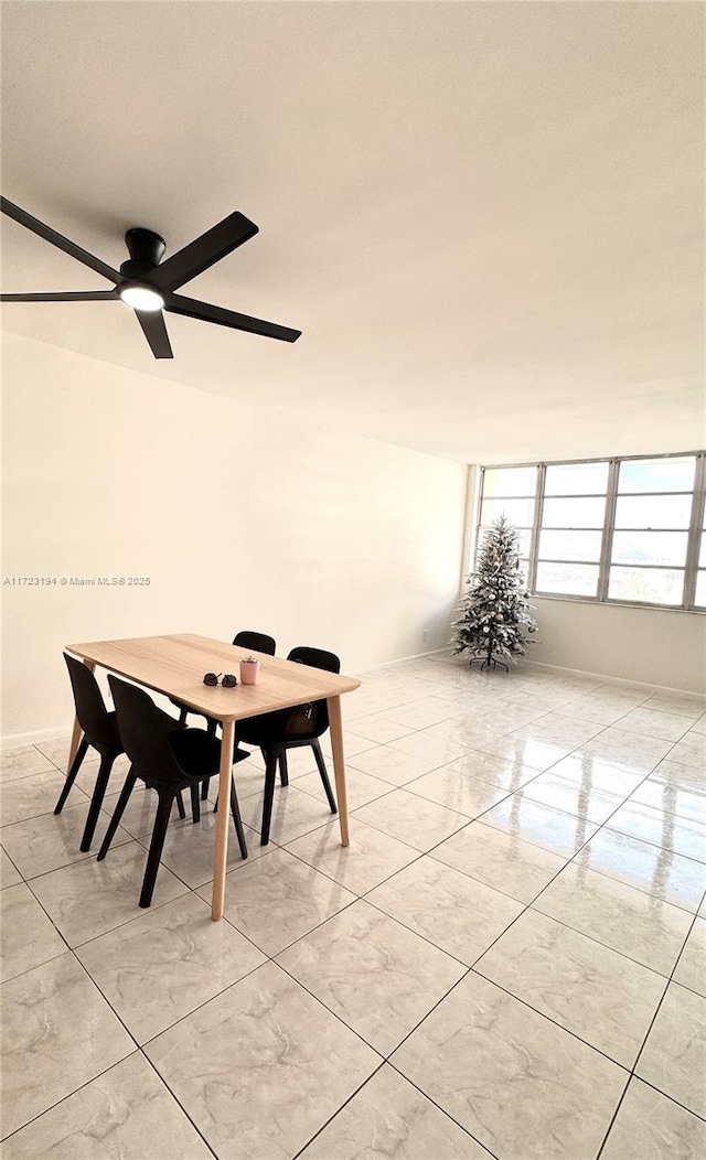 unfurnished dining area featuring ceiling fan