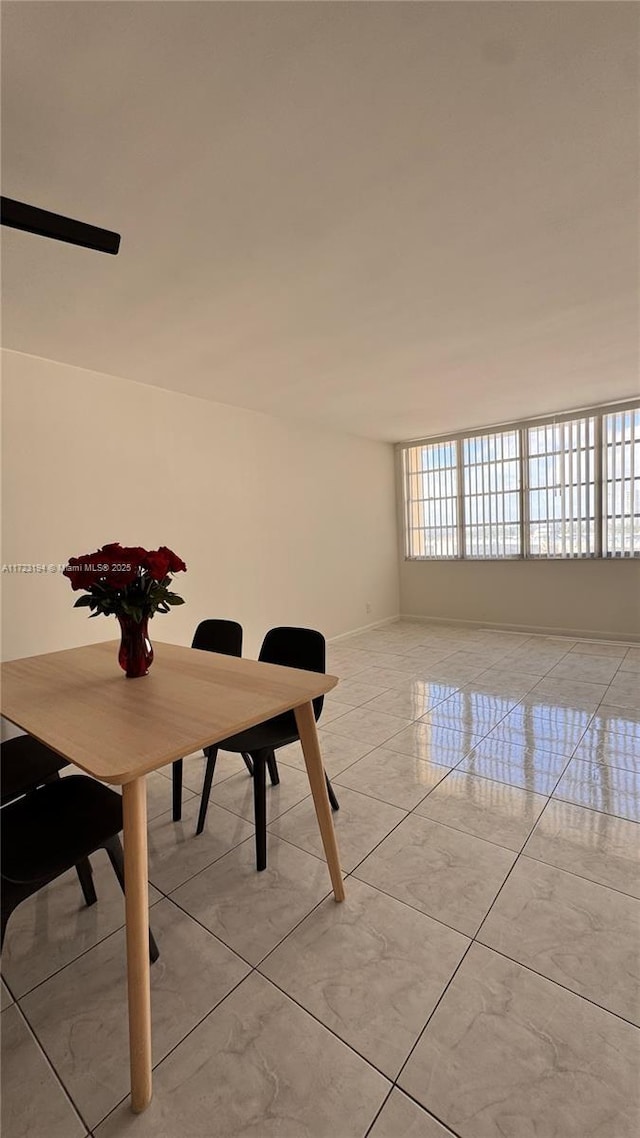 unfurnished dining area featuring marble finish floor