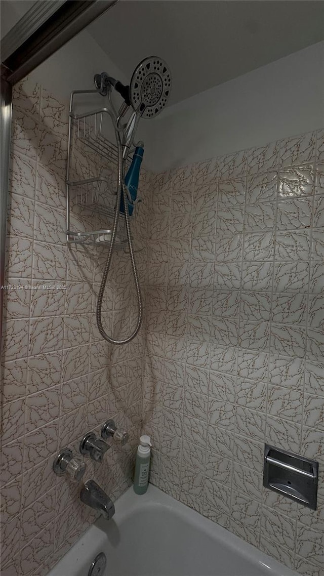 details with tiled shower / bath combo