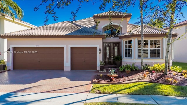 mediterranean / spanish-style house with a garage