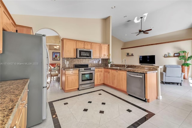 kitchen with ceiling fan, sink, tasteful backsplash, light tile patterned floors, and appliances with stainless steel finishes