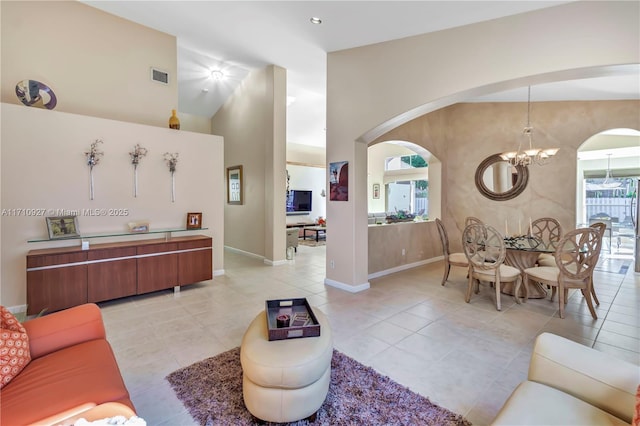 tiled living room with an inviting chandelier