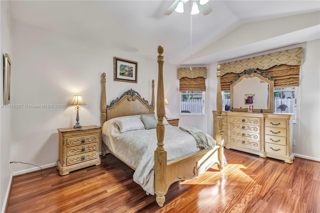 bedroom with hardwood / wood-style floors, ceiling fan, and vaulted ceiling