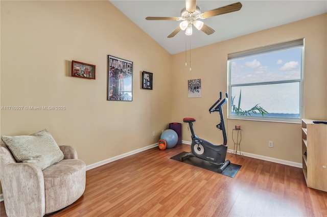 exercise area featuring hardwood / wood-style floors, ceiling fan, and lofted ceiling