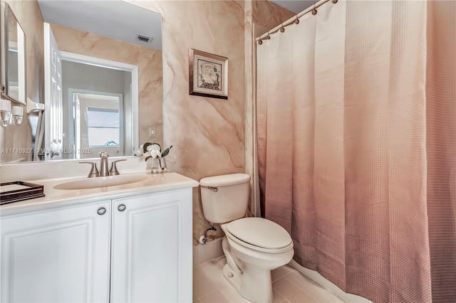 bathroom featuring tile patterned floors, vanity, and toilet