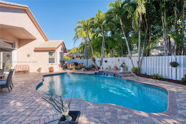 view of pool featuring pool water feature and a patio