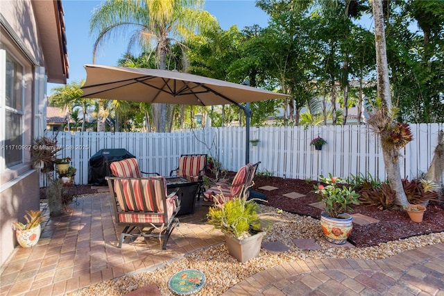 view of patio with an outdoor fire pit and a grill