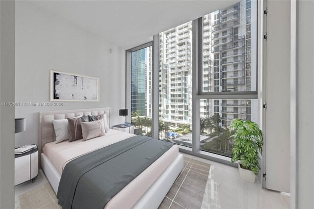 bedroom with a wall of windows and access to exterior