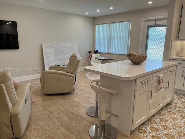 kitchen with stainless steel fridge, electric range oven, sink, light tile patterned floors, and white cabinets