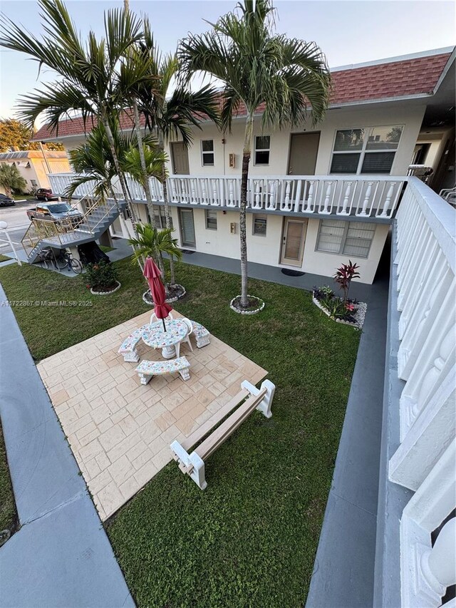 view of home's community with a patio area and a yard