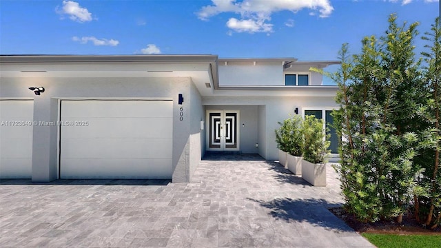 view of front of house with a garage and french doors