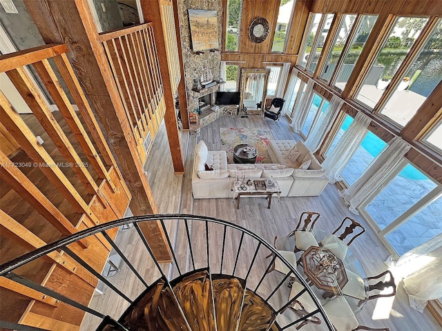 stairs featuring a high ceiling and hardwood / wood-style flooring