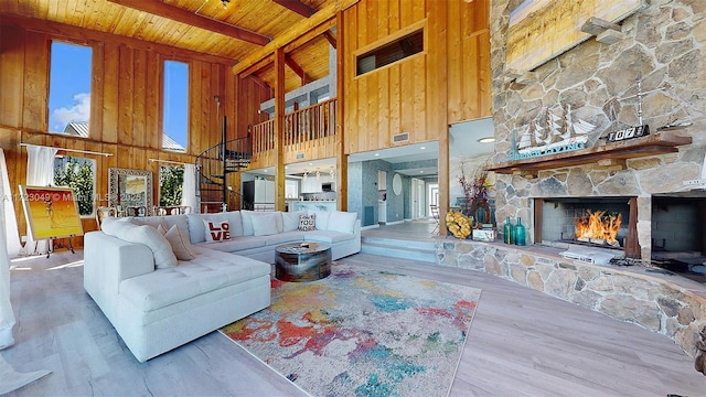 living room featuring hardwood / wood-style floors, a towering ceiling, and wood ceiling