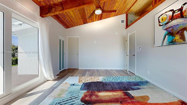 corridor with lofted ceiling with beams, light hardwood / wood-style flooring, and wooden ceiling