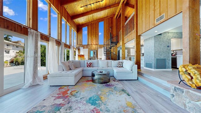 sunroom featuring lofted ceiling with beams and wood ceiling