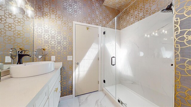 bathroom featuring vanity and a shower with door