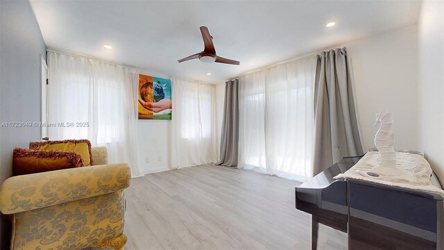 sitting room with ceiling fan, plenty of natural light, and light hardwood / wood-style flooring