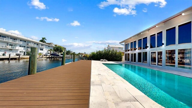 view of pool featuring a patio area and a water view