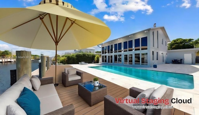 view of swimming pool featuring a patio area, a deck with water view, and an outdoor hangout area