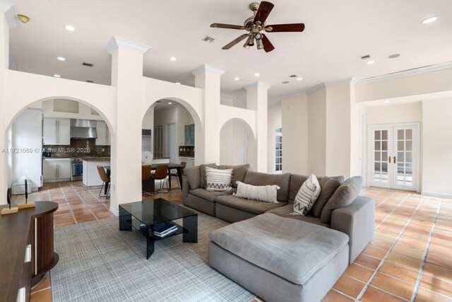 living room with crown molding, light tile patterned floors, ceiling fan, and french doors