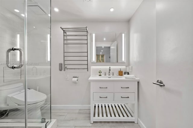 bathroom featuring hardwood / wood-style floors, vanity, toilet, and a shower with shower door