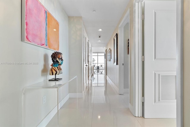 hall with light tile patterned floors