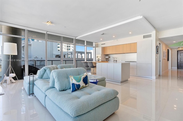 living room featuring light tile patterned floors and expansive windows