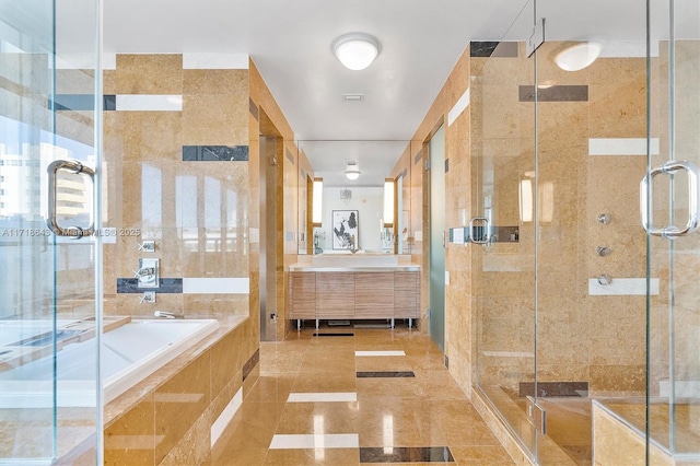 bathroom featuring vanity, plus walk in shower, and tile walls