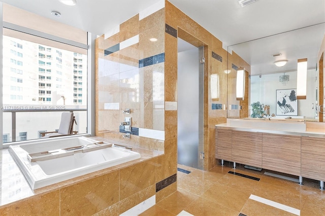 bathroom with vanity, separate shower and tub, and tile walls