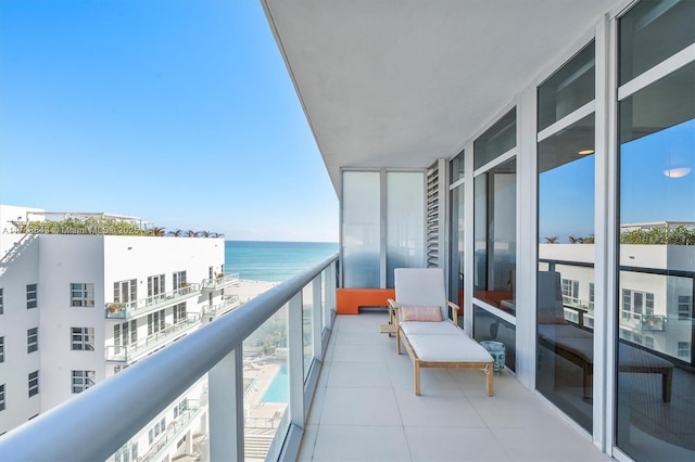 balcony with a water view and a beach view