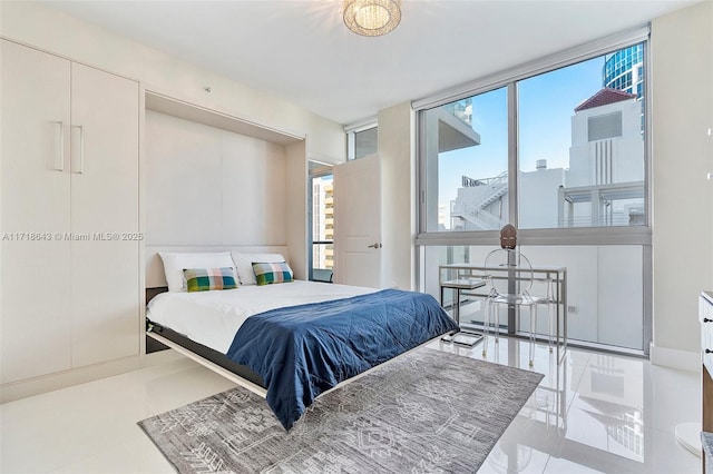 bedroom featuring floor to ceiling windows and multiple windows